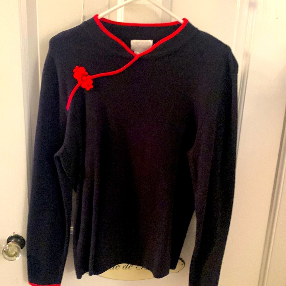 Black designer sweater with red piping and frog